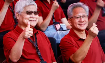Che-chia Wei, TSMC-Chef, und NVIDIA-Gründer Jensen Huang sitzen nebeneinander in roten Polohemden und lachen in die Kamera. Wei zeigt einen Daumen hoch, Huang ein Herzzeichen.