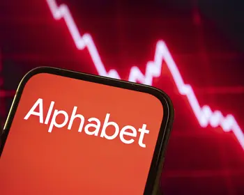 Alphabet Corporate Branding auf dem Smartphone Bildschirm vor rotem, sinkendem Börsendiagramm. 