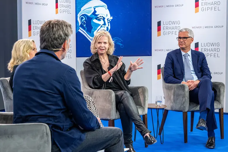 Podiumsdiskussion mit mehreren Personen auf einer Bühne beim Ludwig-Erhard-Gipfel.